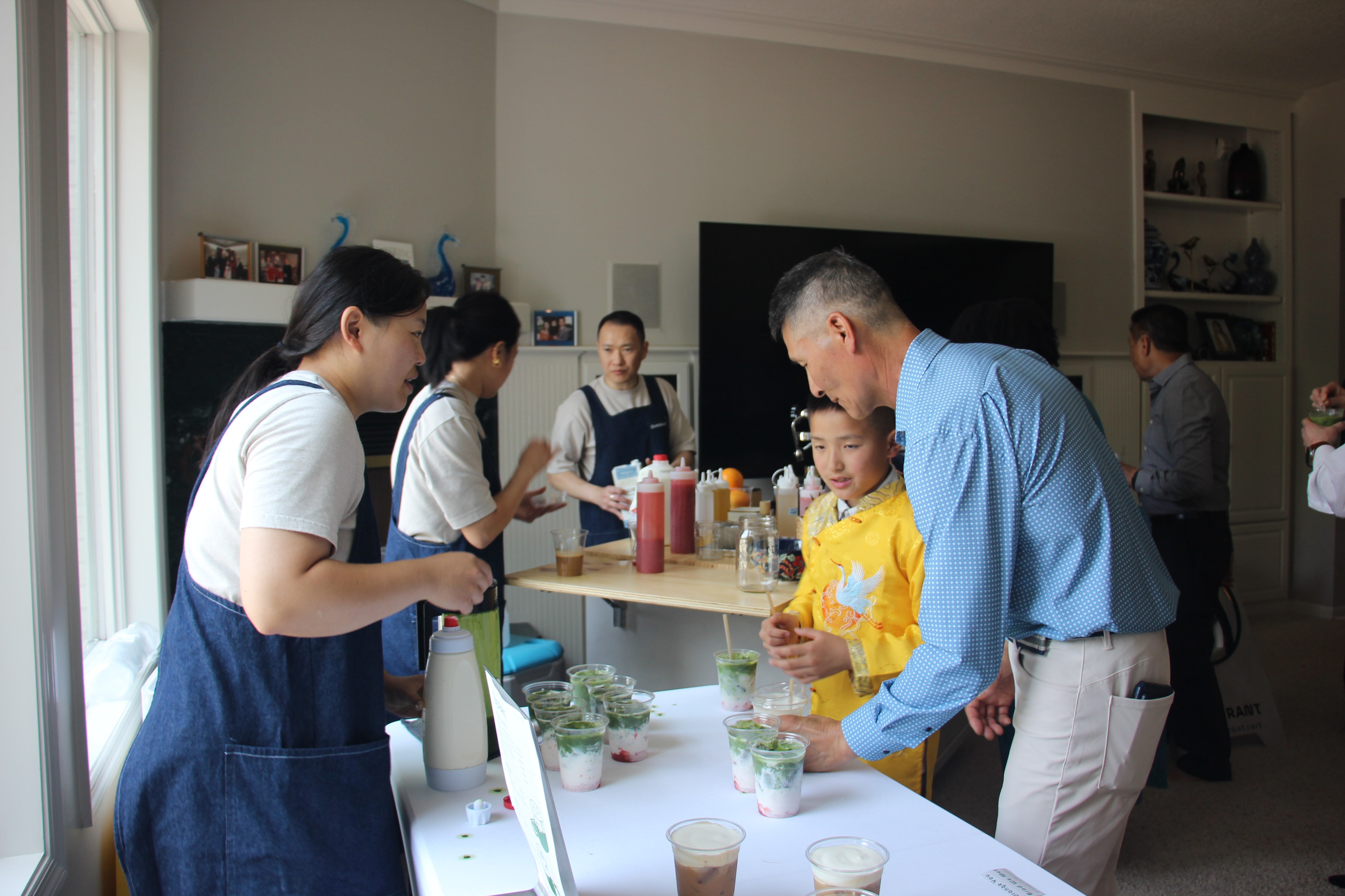 Guests receiving layered matcha drinks from Quadrant Cart at a celebration