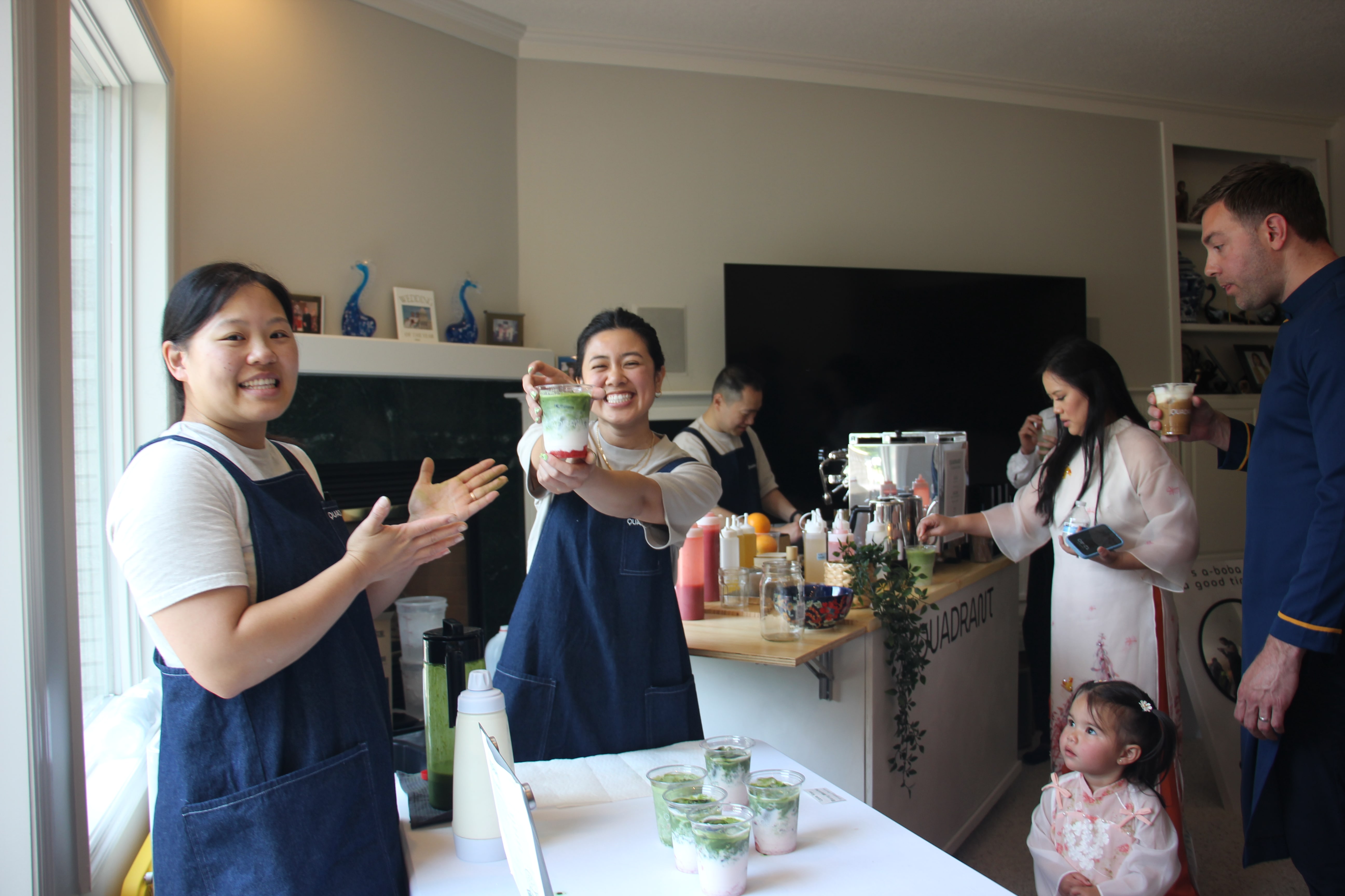Quadrant Cart team member presenting a layered matcha drink to event guests