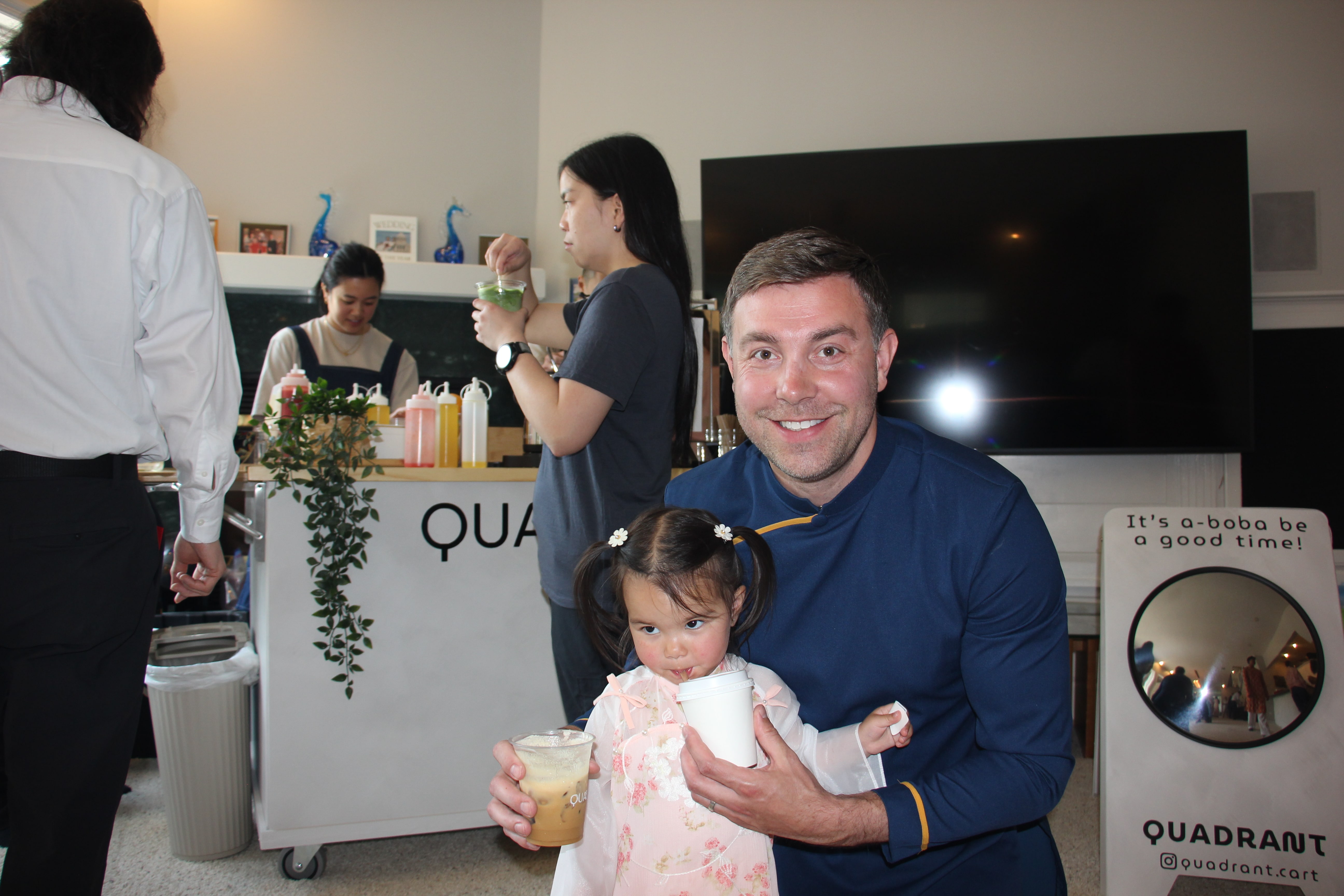 Family enjoying handcrafted drinks beside the Quadrant Cart at a celebration