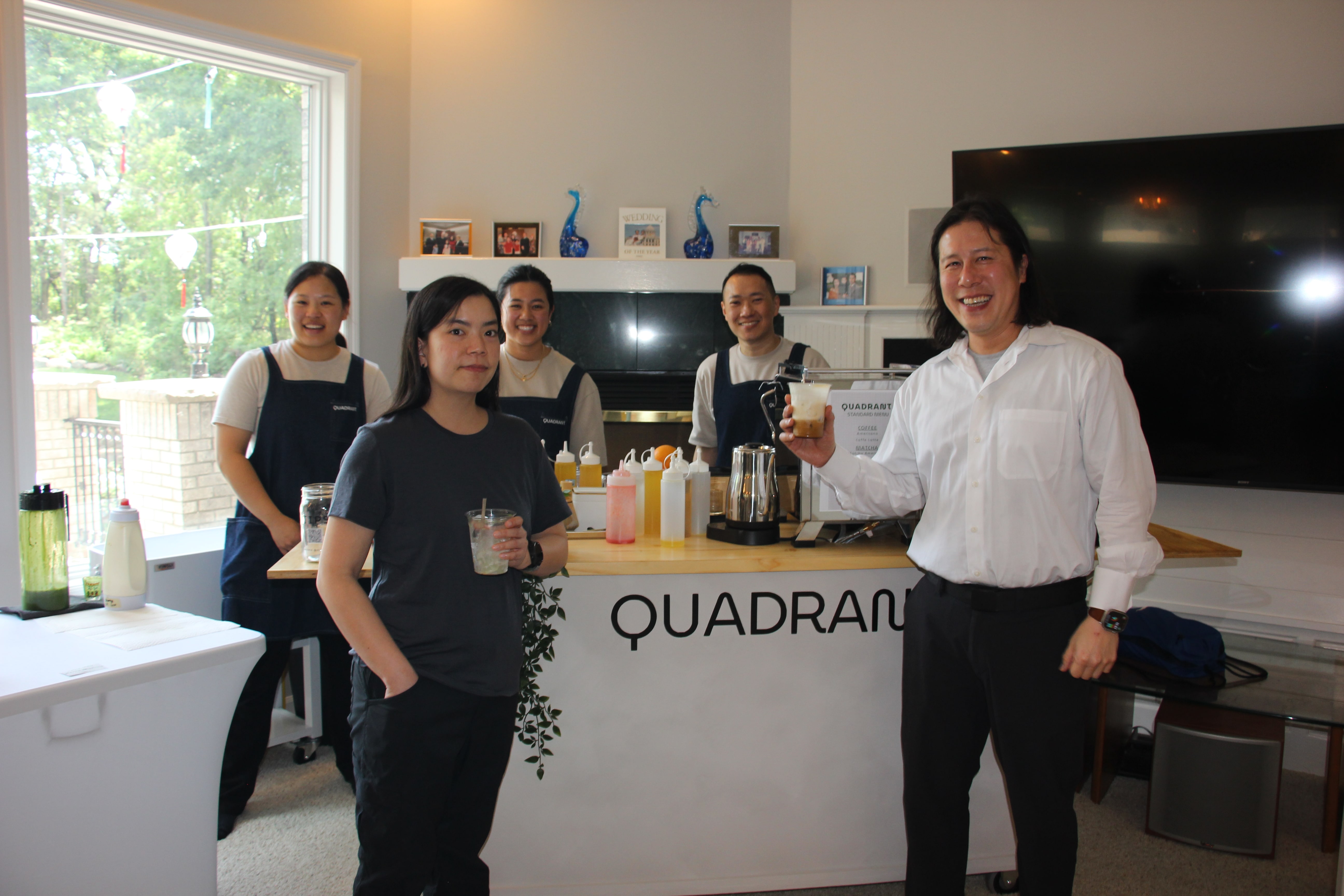 Event guests posing with the Quadrant Cart team and mobile cafe setup