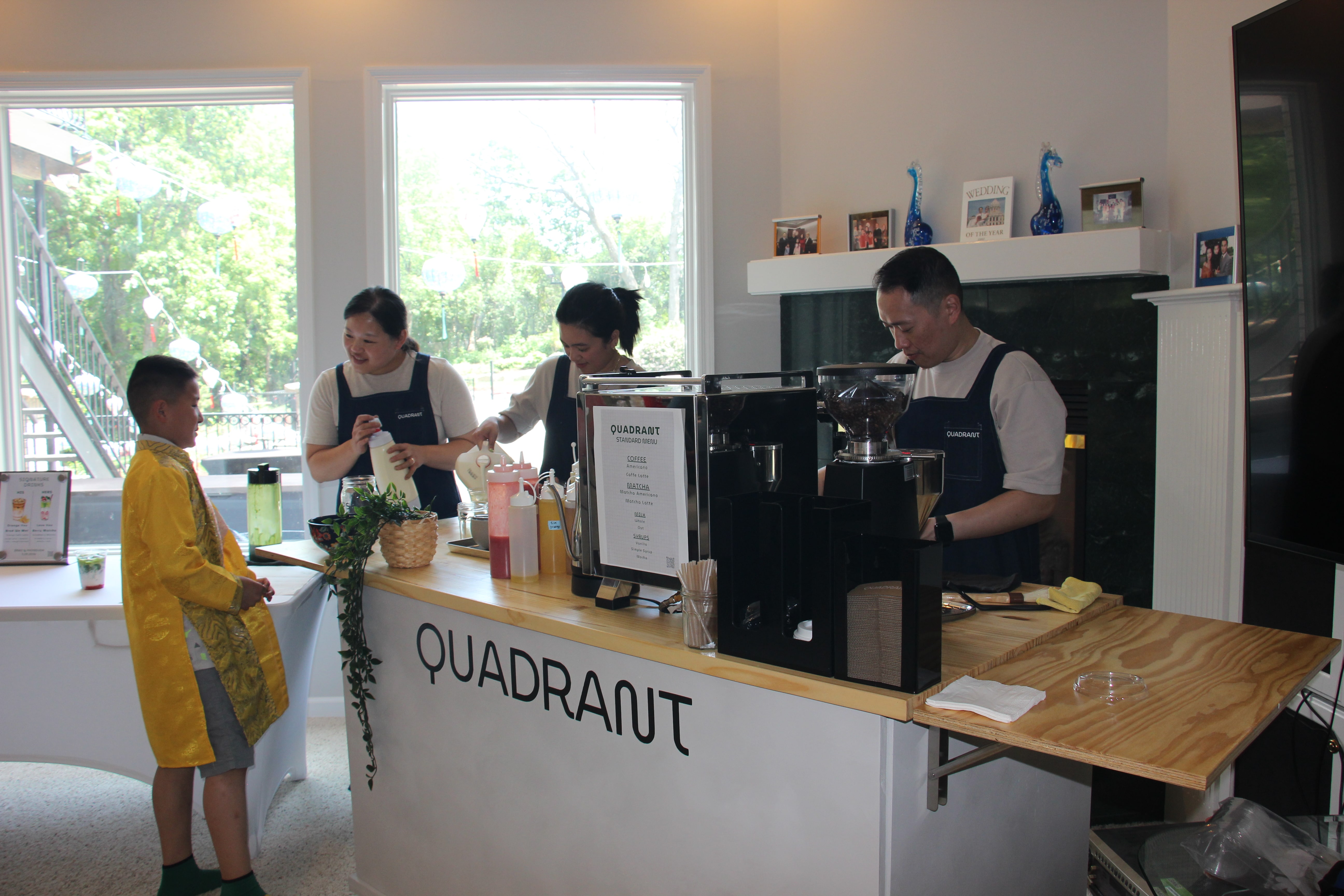 Quadrant Cart baristas serving a young guest from the full coffee and matcha cart
