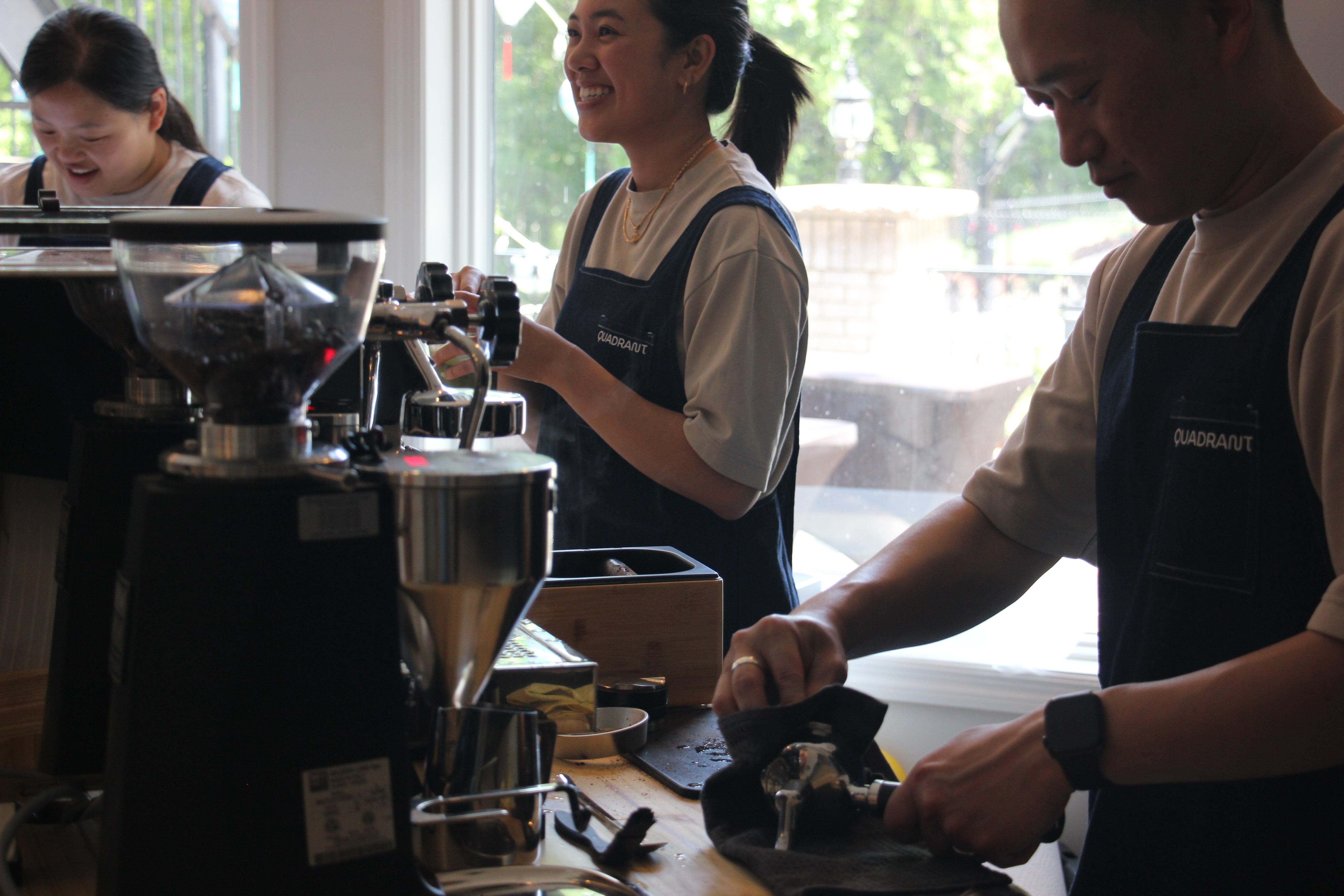 Quadrant Cart baristas preparing espresso drinks behind the mobile cart