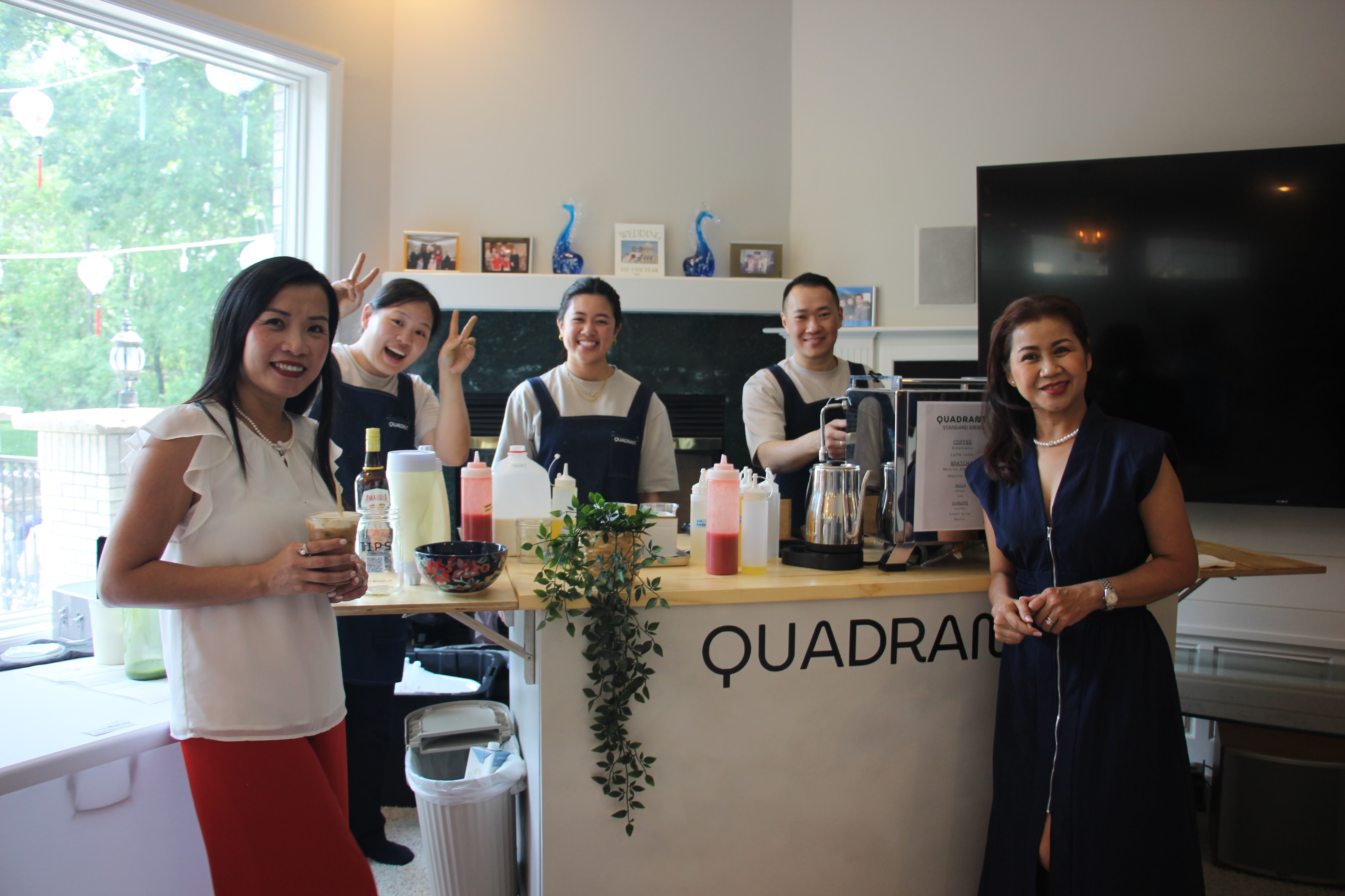 Celebration guests posing with the smiling Quadrant Cart team