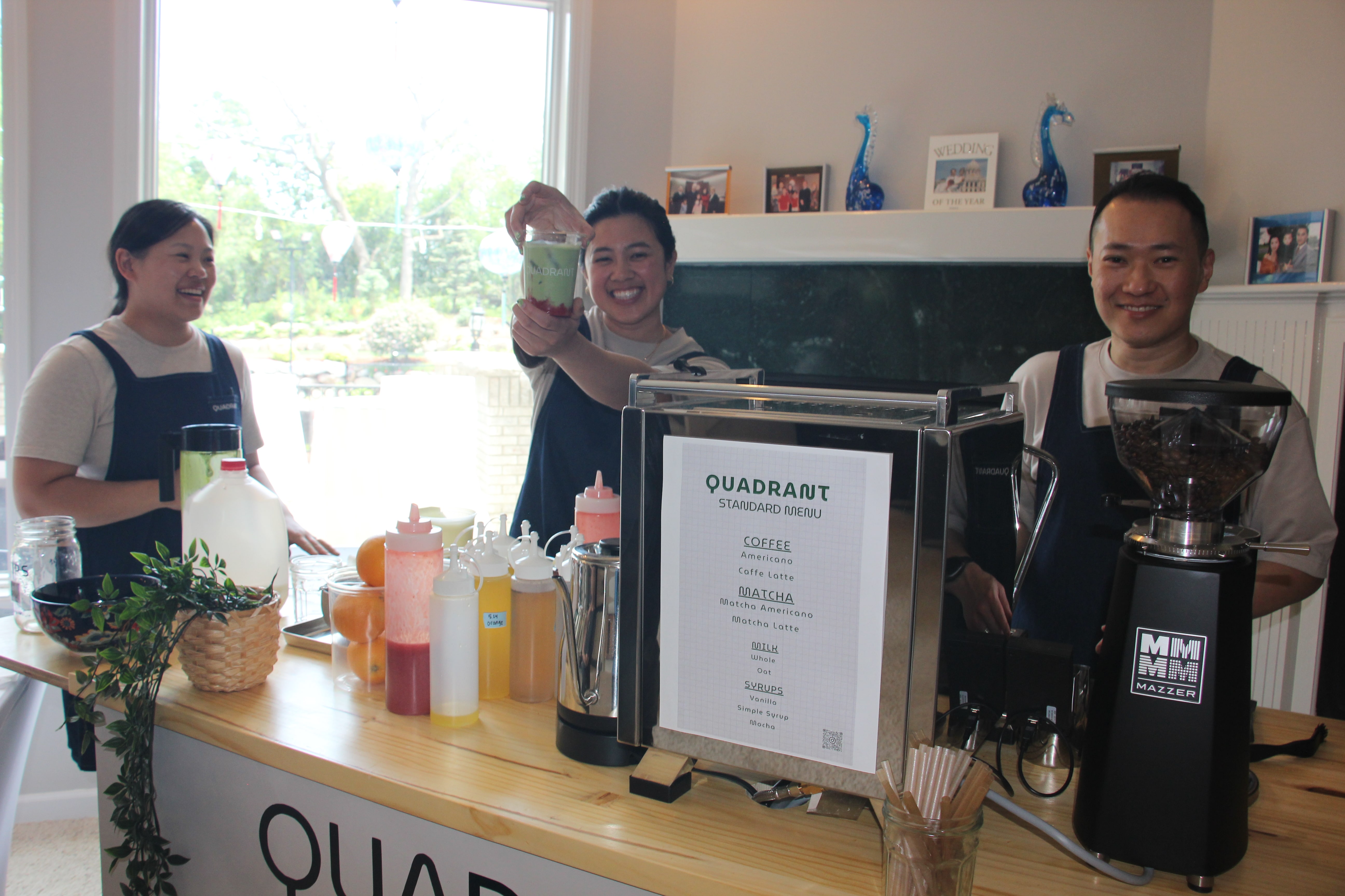 Quadrant Cart team showing a layered matcha drink behind the event cart