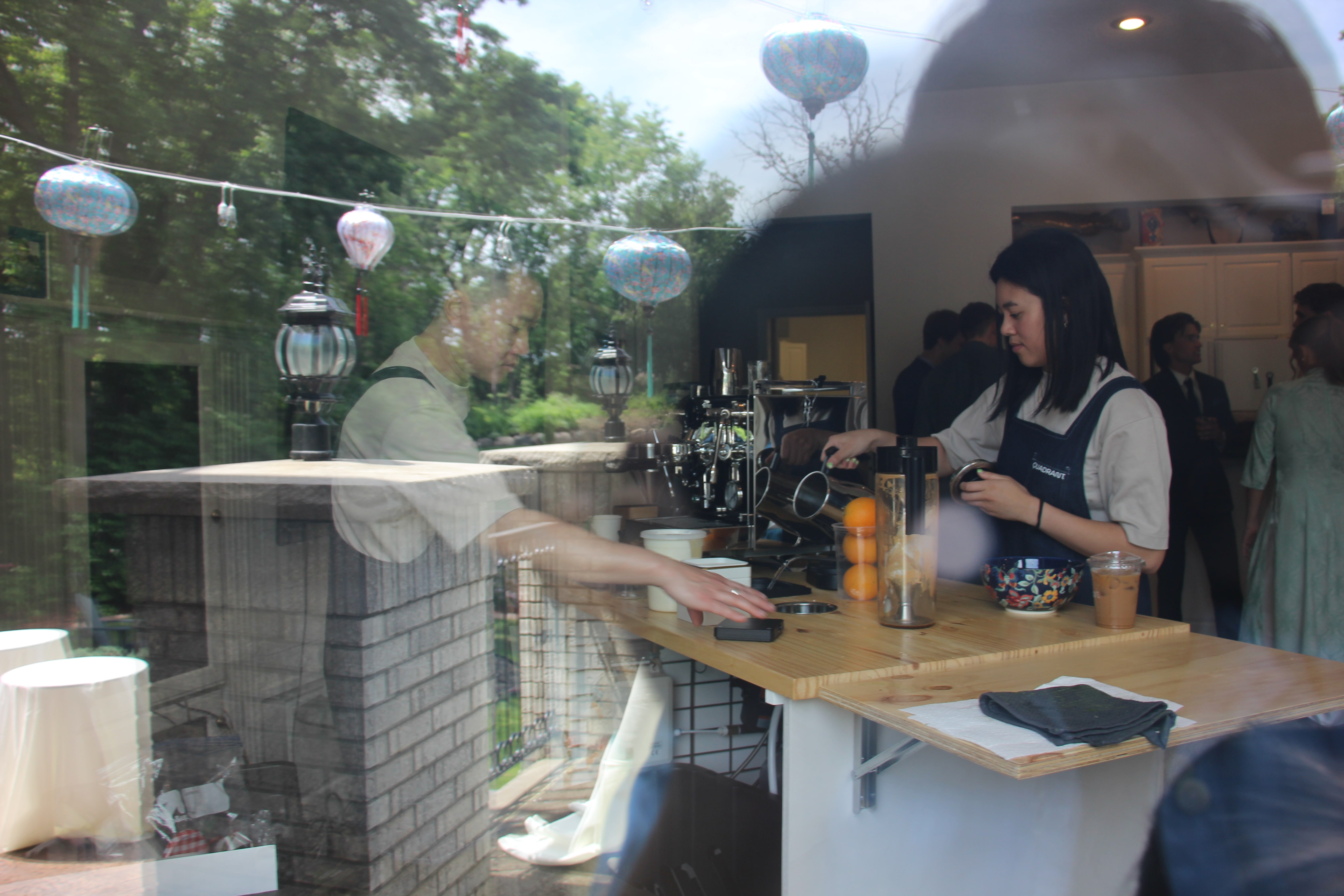 Quadrant Cart drink service photographed through a reflective event window